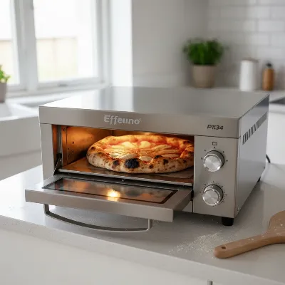 Effeuno P134 indoor electric pizza oven on a kitchen counter with a pizza inside, showcasing its professional design